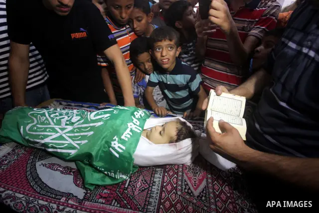 Palestinian mourners pray over the body of Hadeel al-Hadad during her funeral in Gaza City on 20 June 2012. Hadeel was killed June 19 when Palestinian militants launched a rocket from Gaza City, which failed to reach its...