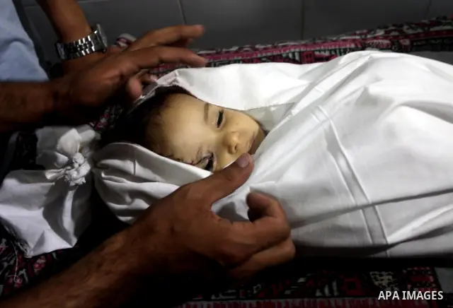 Palestinian mourners pray over the body of Hadeel al-Hadad during her funeral in Gaza City on 20 June 2012. Hadeel was killed June 19 when Palestinian militants launched a rocket from Gaza City, which failed to reach its...