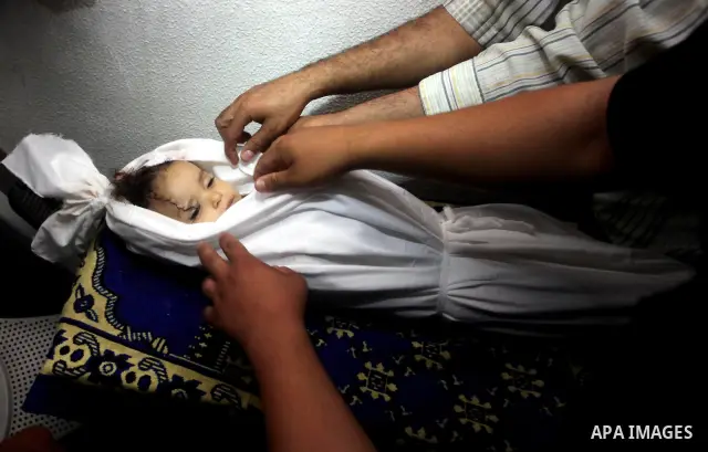 Palestinian mourners pray over the body of Hadeel al-Hadad during her funeral in Gaza City on 20 June 2012. Hadeel was killed June 19 when Palestinian militants launched a rocket from Gaza City, which failed to reach its...