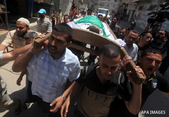 Palestinians carry the body of 14-year-old Mamon al-Dam during his funeral in Gaza City June 21, 2012. Gaza militants said on Wednesday they were ready to sign up to an Egyptian-brokered truce to end three days of cross-...