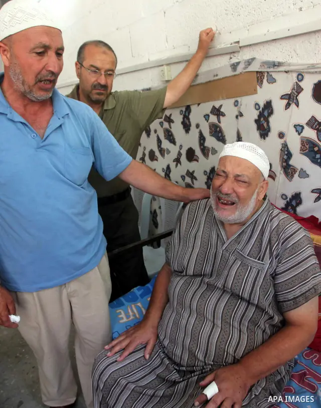 Palestinian Mohammed al-Dam grieves during the funeral of his son Mamon al-Dam, 14, in Gaza City, Thursday, June 21, 2012. Al Dam was killed on Wednesday during an Israeli air strike while he was playing at his family fa...