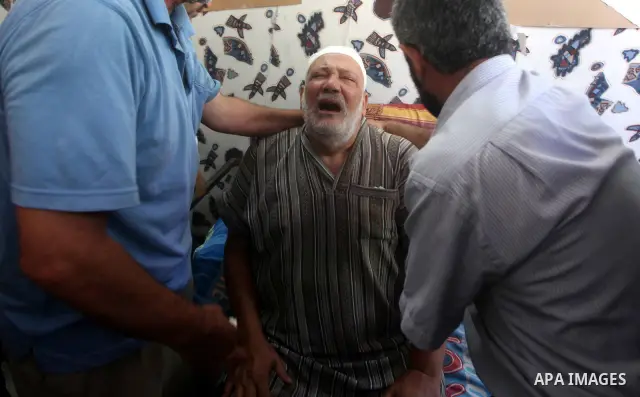 Palestinian Mohammed al-Dam grieves during the funeral of his son Mamon al-Dam, 14, in Gaza City, Thursday, June 21, 2012. Al Dam was killed on Wednesday during an Israeli air strike while he was playing at his family fa...