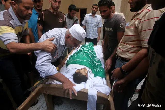 Palestinian Mohammed al-Dam grieves during the funeral of his son Mamon al-Dam, 14, in Gaza City, Thursday, June 21, 2012. Al Dam was killed on Wednesday during an Israeli air strike while he was playing at his family fa...