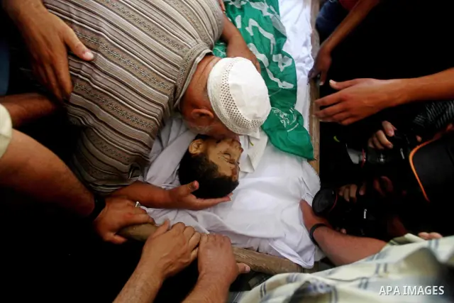 Palestinian Mohammed al-Dam grieves during the funeral of his son Mamon al-Dam, 14, in Gaza City, Thursday, June 21, 2012. Al Dam was killed on Wednesday during an Israeli air strike while he was playing at his family fa...