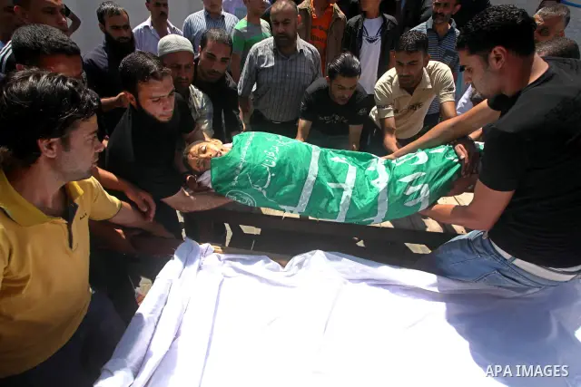 Palestinians carry the body of 14-year-old Mamon al-Dam during his funeral in Gaza City June 21, 2012. Gaza militants said on Wednesday they were ready to sign up to an Egyptian-brokered truce to end three days of cross-...