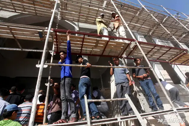 Palestinians look at the bodies of militants of al-Qassam brigades Thair Al-Baik, and Mohammed al-Khaldi, during their funeral in Jabalia refugee camp in the northern Gaza Strip on June 21, 2012. Two armed wing of hamas...