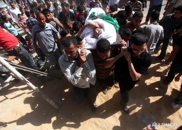 Palestinian mourners carry the body of a militant of al-Qassam brigades Thair Al-Baik, 30, during his funeral in Jabalia refugee camp in the northern Gaza Strip on June 21, 2012. Al-Baik one of two fighters from al-Qassa...