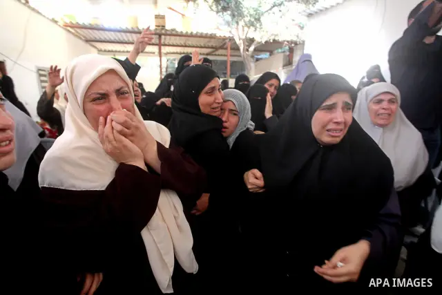 Palestinian relatives of a militant of al-Qassam brigades Thair Al-Baik, 30, mourn during his funeral in Jabalia refugee camp in the northern Gaza Strip on June 21, 2012. Al-Baik one of two fighters from al-Qassam brigad...
