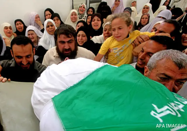 A daughter of a Palestinian militant of al-Qassam brigades Thair Al-Baik mourns during his funeral in Jabalya camp in the northern Gaza Strip June 21, 2012. Al-Baik one of two fighters from al-Qassam brigades the armed w...