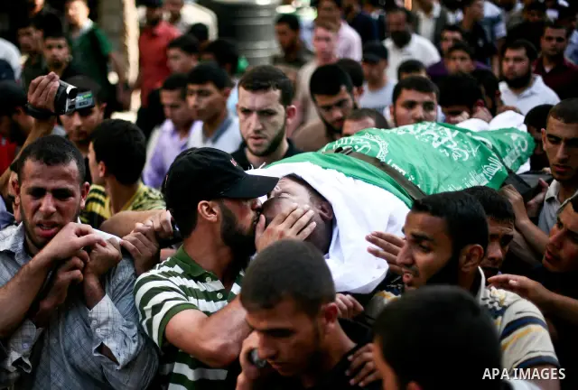 Palestinian mourners carry the body of Hamas militant Thair al-Bik, and Mohammed al-Khaldi , during their funeral in Jabaliya Refugee Camp, northern Gaza Strip, Thursday, June 21, 2012. Al-Bik and Al-Khaldi two Hamas mil...