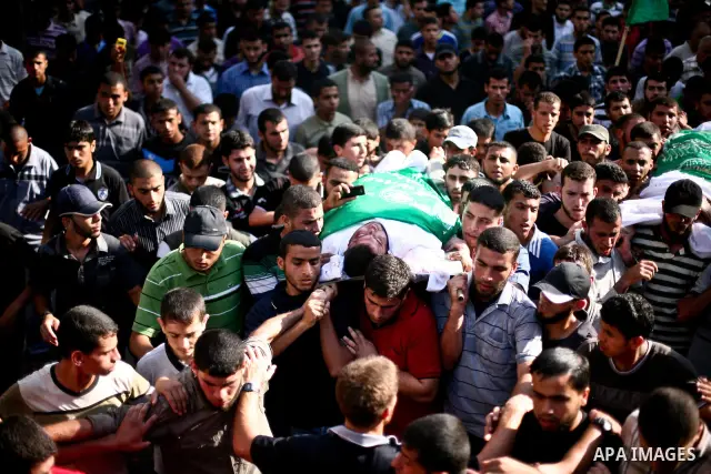 Palestinian mourners carry the body of Hamas militant Thair al-Bik, and Mohammed al-Khaldi , during their funeral in Jabaliya Refugee Camp, northern Gaza Strip, Thursday, June 21, 2012. Al-Bik and Al-Khaldi two Hamas mil...