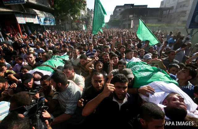 Palestinian mourners carry the body of Hamas militant Thair al-Bik, and Mohammed al-Khaldi , during their funeral in Jabaliya Refugee Camp, northern Gaza Strip, Thursday, June 21, 2012. Al-Bik and Al-Khaldi two Hamas mil...