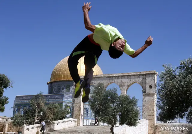 Palestinian child plays during the summer camps at Al-Aqsa mosque in the old city of Jerusalem on 21 June 2012. Photo by Mahfouz Abu Turk.