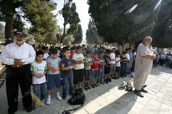 Palestinian children pray during a participate in summer camps at Al-Aqsa mosque in the old city of Jerusalem on 20 June 2012. Photo by Mahfouz Abu Turk