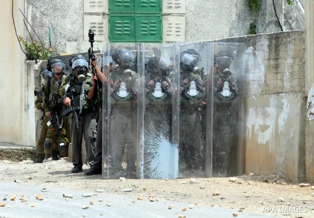 Israeli Soldiers getting ready to fire a tear gas during clashes with Palestinian demonstrators following a weekly protest against the Jewish settlement of Kdumim, near Nablus,in the northern West Bank village of Kufr Qa...