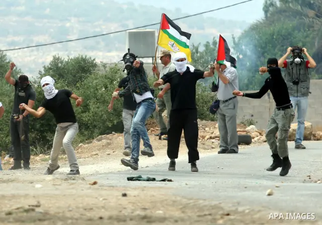 Palestinian demonstrators throw stones during clashes following a weekly protest against the Jewish settlement of Kdumim, near Nablus,in the northern West Bank village of Kufr Qaddum, June 22, 2012. According to medical...