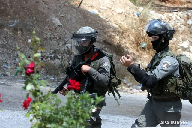 An Israeli soldier fires a tear gas canister during clashes with Palestinian protesters in the West Bank village of Nabi Saleh, near Ramallah, on June 22, 2012, following a demonstration against the confiscation of Pales...