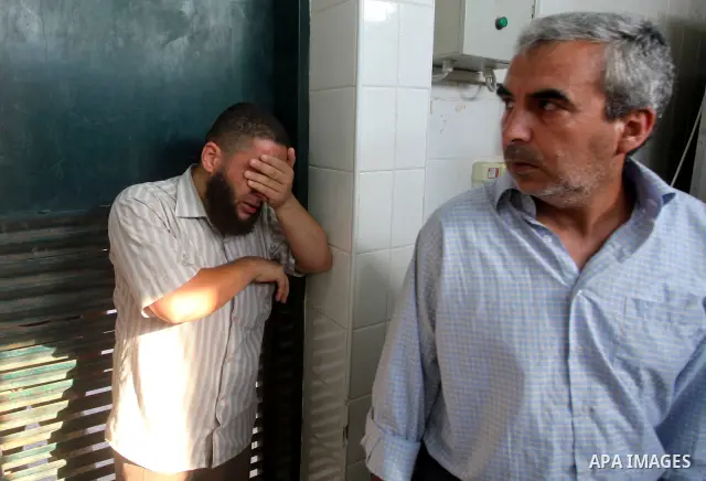 Relatives of wounded Palestinians mourn, at al-Aqsa hospital following an Israeli airstrike east of Bureij refugee camp, in Deir Al Balah, central Gaza strip, Friday, June 22, 2012. An Israeli air strike killed a Palesti...