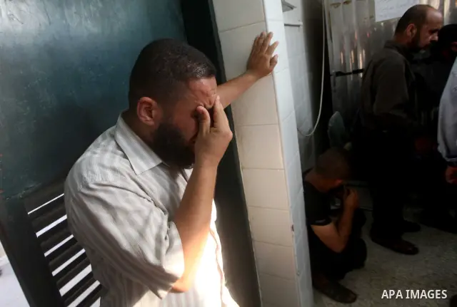 Relatives of wounded Palestinians mourn, at al-Aqsa hospital following an Israeli airstrike east of Bureij refugee camp, in Deir Al Balah, central Gaza strip, Friday, June 22, 2012. An Israeli air strike killed a Palesti...