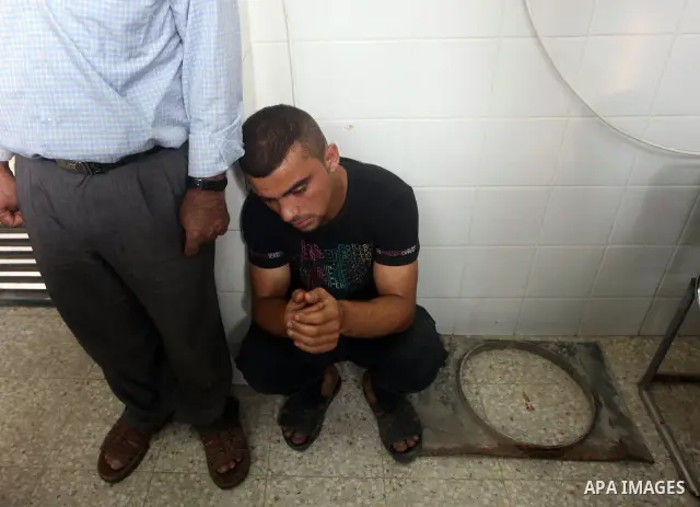 Relatives of wounded Palestinians mourn, at al-Aqsa hospital following an Israeli airstrike east of Bureij refugee camp, in Deir Al Balah, central Gaza strip, Friday, June 22, 2012. An Israeli air strike killed a Palesti...