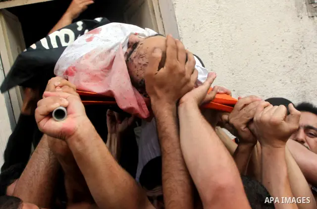Palestinian mourners carry the body of militant Basil Ahmad during his funeral in Bureij refugee camp, central Gaza Strip, Friday, June 22, 2012. Palestinian sources say that Ahmad was killed during an Israeli airstrike...