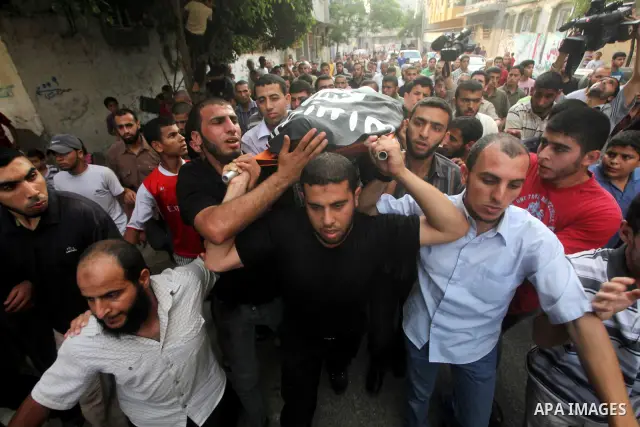 Palestinian mourners carry the body of militant Basil Ahmad during his funeral in Bureij refugee camp, central Gaza Strip, Friday, June 22, 2012. Palestinian sources say that Ahmad was killed during an Israeli airstrike...