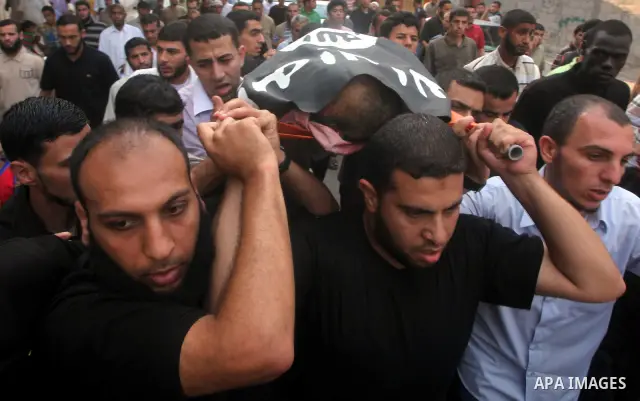 Palestinian mourners carry the body of militant Basil Ahmad during his funeral in Bureij refugee camp, central Gaza Strip, Friday, June 22, 2012. Palestinian sources say that Ahmad was killed during an Israeli airstrike...
