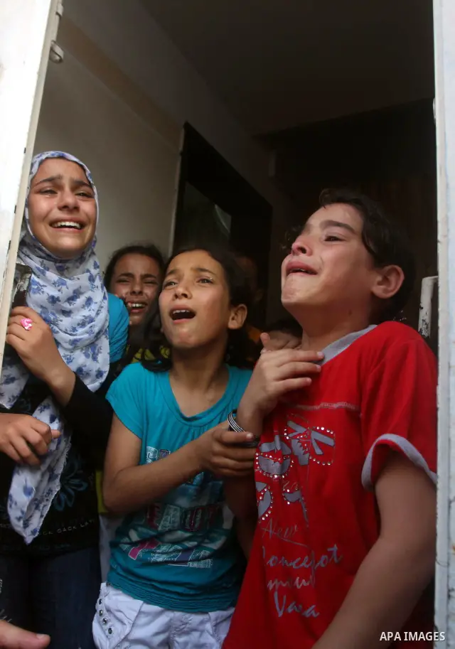 Relatives of Palestinian militant Basil Ahmed mourn during his funeral in Bureij refugee camp, central Gaza Strip, Friday, June 22, 2012. Palestinian sources say that Ahmad was killed during an Israeli airstrike east of...