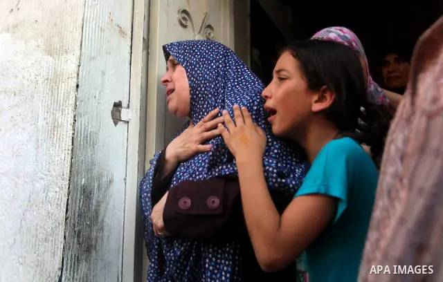 Relatives of Palestinian militant Basil Ahmed mourn during his funeral in Bureij refugee camp, central Gaza Strip, Friday, June 22, 2012. Palestinian sources say that Ahmad was killed during an Israeli airstrike east of...