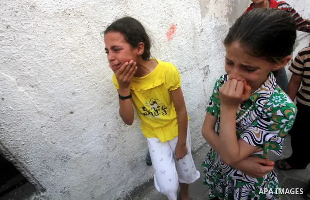 Relatives of Palestinian militant Basil Ahmed mourn during his funeral in Bureij refugee camp, central Gaza Strip, Friday, June 22, 2012. Palestinian sources say that Ahmad was killed during an Israeli airstrike east of...