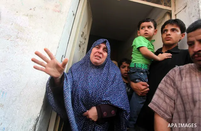 Relatives of Palestinian militant Basil Ahmed mourn during his funeral in Bureij refugee camp, central Gaza Strip, Friday, June 22, 2012. Palestinian sources say that Ahmad was killed during an Israeli airstrike east of...