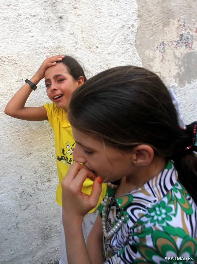 Relatives of Palestinian militant Basil Ahmed mourn during his funeral in Bureij refugee camp, central Gaza Strip, Friday, June 22, 2012. Palestinian sources say that Ahmad was killed during an Israeli airstrike east of...