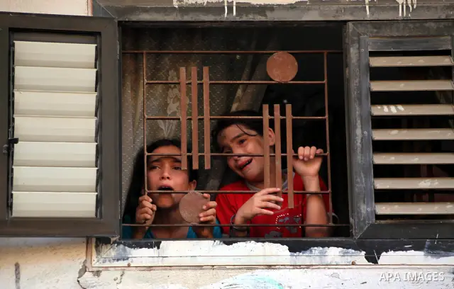 Relatives of Palestinian militant Basil Ahmed mourn during his funeral in Bureij refugee camp, central Gaza Strip, Friday, June 22, 2012. Palestinian sources say that Ahmad was killed during an Israeli airstrike east of...