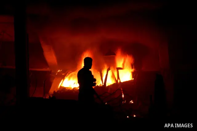 Hamas Police and firemen look at the damages and try to put out a fire at the al-Saraya Security complex following an Israeli air strike on Gaza on June 23, 2012. Israel launched more air strikes against on the Gaza Stri...