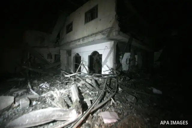 A Palestinian Hamas security personnel inspects the destroyed Al Saraya compound after its was hit in an Israeli air strike in the central Gaza city, early 23 June 2012. Israeli war jets killed two Palestinian militants...