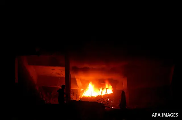 Hamas Police and firemen look at the damages and try to put out a fire at the al-Saraya Security complex following an Israeli air strike on Gaza on June 23, 2012. Israel launched more air strikes against on the Gaza Stri...