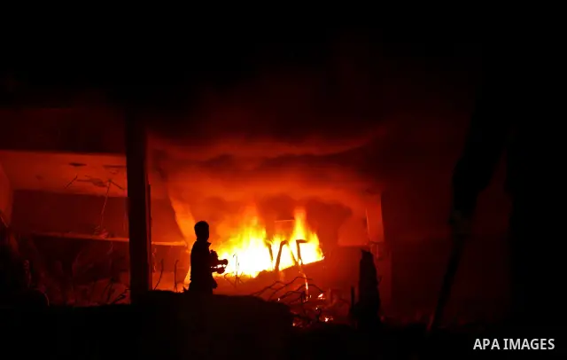 Hamas Police and firemen look at the damages and try to put out a fire at the al-Saraya Security complex following an Israeli air strike on Gaza on June 23, 2012. Israel launched more air strikes against on the Gaza Stri...
