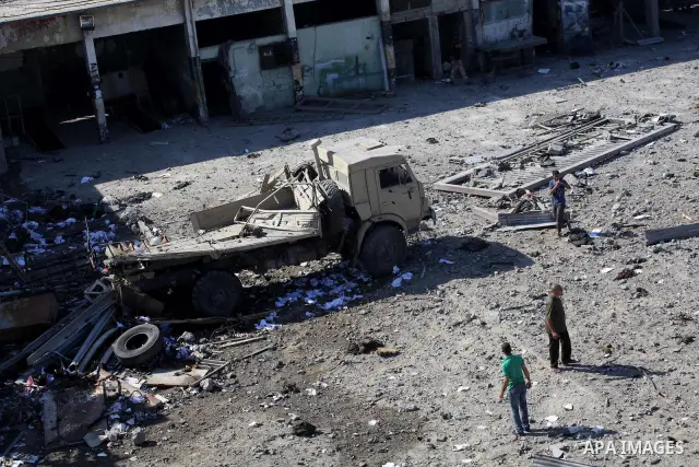 Palestinian Hamas security personnel inspect the damage at al-Saraya Security complex in the centre of Gaza City on June 23, 2012 as Israel launched fresh air strikes on the Gaza Strip overnight after killing two people...
