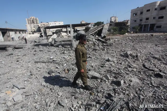Palestinian Hamas security personnel inspect the damage at al-Saraya Security complex in the centre of Gaza City on June 23, 2012 as Israel launched fresh air strikes on the Gaza Strip overnight after killing two people...