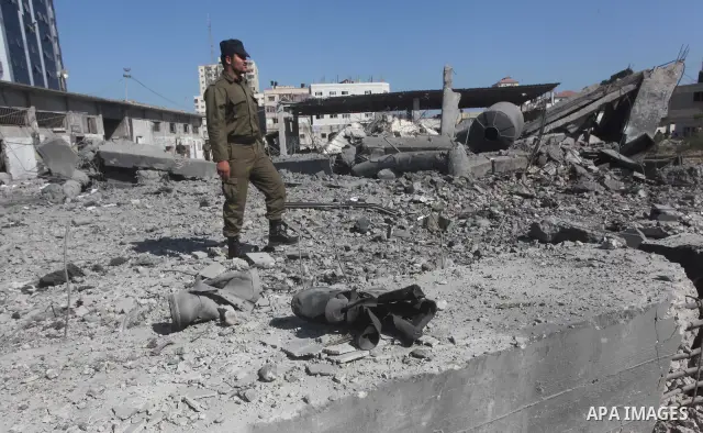 Palestinian Hamas security personnel inspect the damage at al-Saraya Security complex in the centre of Gaza City on June 23, 2012 as Israel launched fresh air strikes on the Gaza Strip overnight after killing two people...