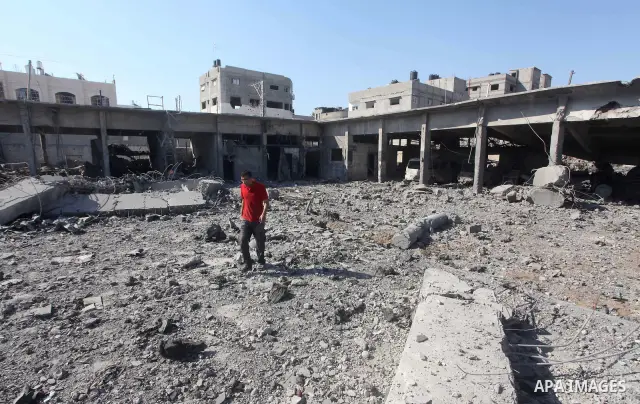 Palestinian Hamas security personnel inspect the damage at al-Saraya Security complex in the centre of Gaza City on June 23, 2012 as Israel launched fresh air strikes on the Gaza Strip overnight after killing two people...