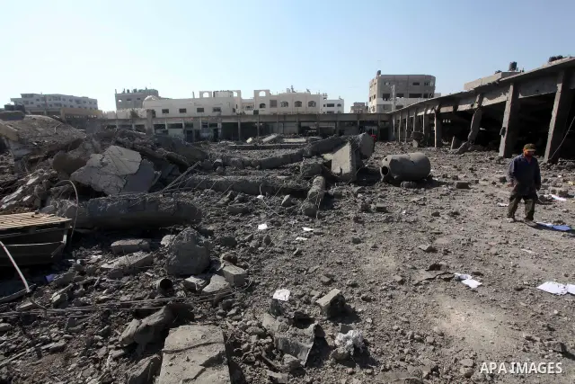 Palestinian Hamas security personnel inspect the damage at al-Saraya Security complex in the centre of Gaza City on June 23, 2012 as Israel launched fresh air strikes on the Gaza Strip overnight after killing two people...