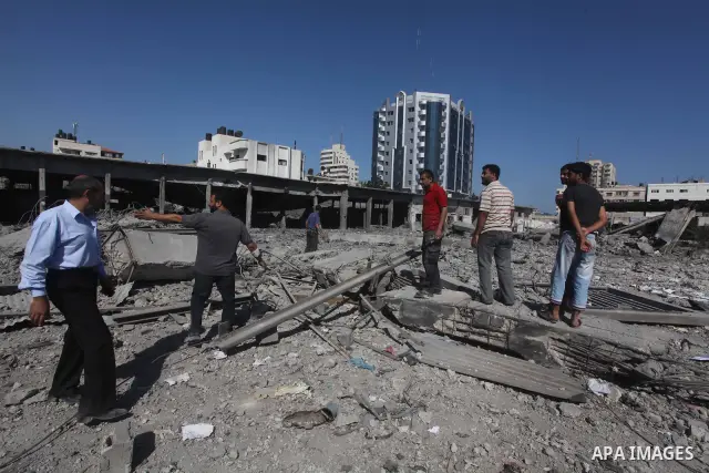 Palestinian Hamas security personnel inspect the damage at al-Saraya Security complex in the centre of Gaza City on June 23, 2012 as Israel launched fresh air strikes on the Gaza Strip overnight after killing two people...