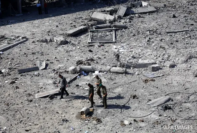 Palestinian Hamas security personnel inspect the damage at al-Saraya Security complex in the centre of Gaza City on June 23, 2012 as Israel launched fresh air strikes on the Gaza Strip overnight after killing two people...