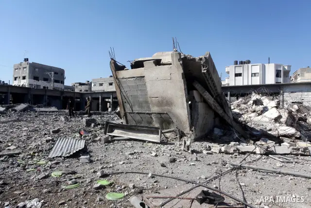 Palestinian Hamas security personnel inspect the damage at al-Saraya Security complex in the centre of Gaza City on June 23, 2012 as Israel launched fresh air strikes on the Gaza Strip overnight after killing two people...