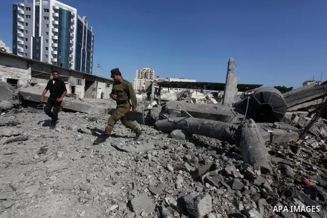 Palestinian Hamas security personnel inspect the damage at al-Saraya Security complex in the centre of Gaza City on June 23, 2012 as Israel launched fresh air strikes on the Gaza Strip overnight after killing two people...