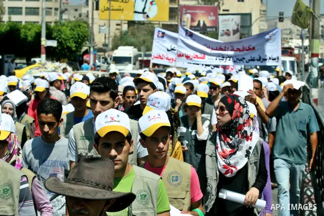 Palestinians wearing hats with the slogan " no for drugs" march in the streets of the West Bank city of Nablus on June 23, 2012 as part of an awareness campaign, entitled "fighting drug", against the consumption of narco...