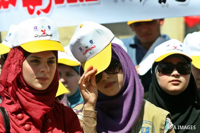 Palestinians wearing hats with the slogan " no for drugs" march in the streets of the West Bank city of Nablus on June 23, 2012 as part of an awareness campaign, entitled "fighting drug", against the consumption of narco...