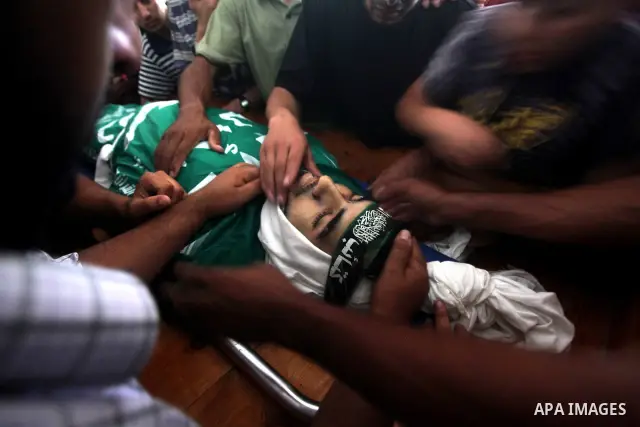 Palestinians carry the body of Hamas militant Hamam Abu Qadus during his funeral in Gaza City June 23, 2012. Israel launched air raids early on Saturday against three Hamas security targets in the Gaza Strip, wounding at...