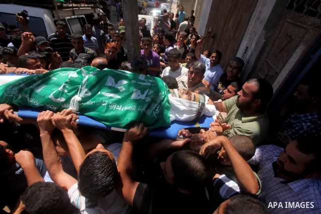 Palestinians carry the body of Hamas militant Hamam Abu Qadus during his funeral in Gaza City June 23, 2012. Israel launched air raids early on Saturday against three Hamas security targets in the Gaza Strip, wounding at...